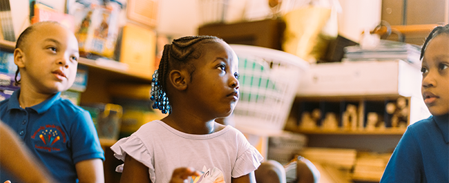 three children in a play room